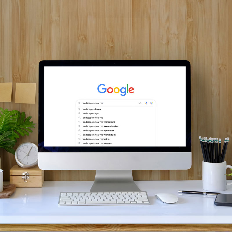 Desktop computer showing "landscaper near me" autopopulating
